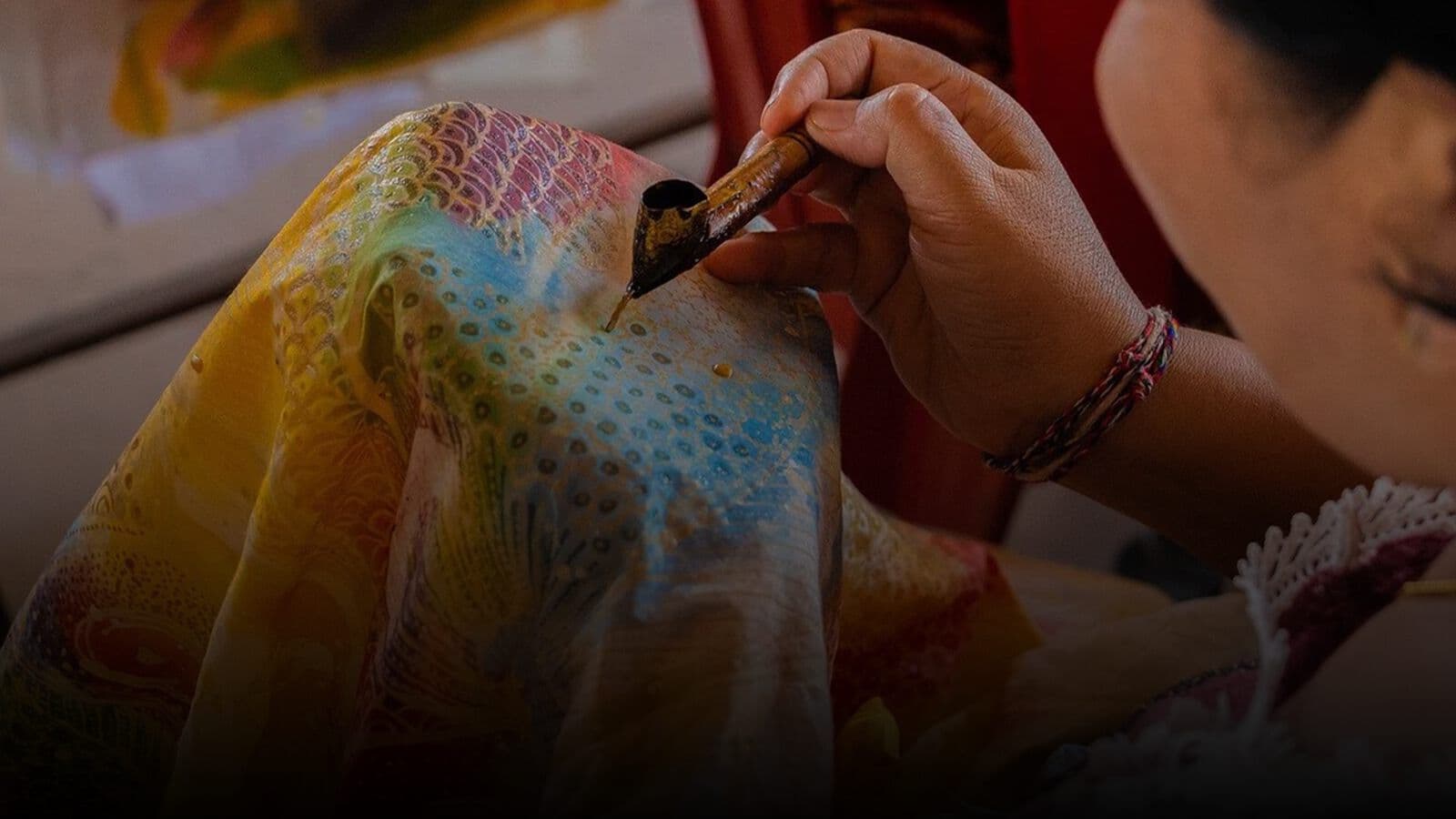 Wax being drawn onto fabric for batik