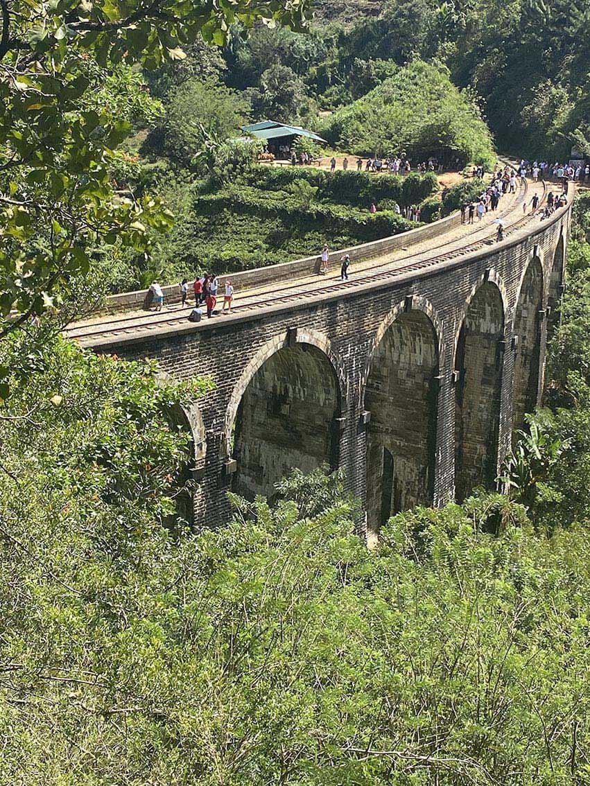 Walkers crossing the Nine Arch Bridge at Ella