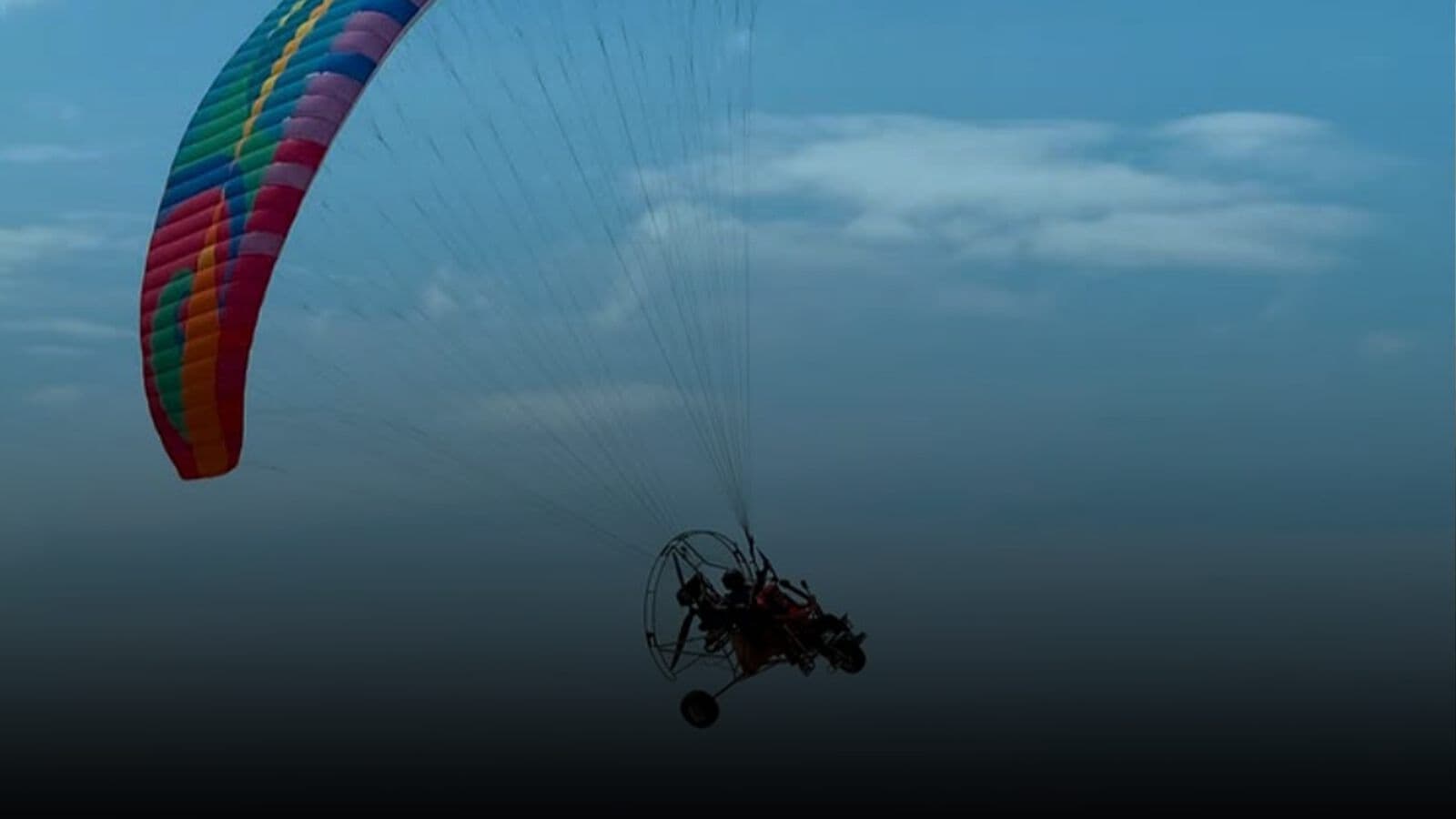 A paramotor in flight over the coast