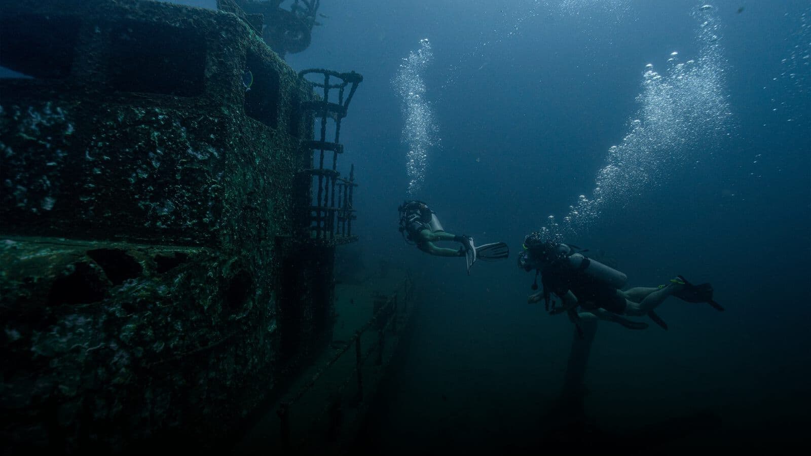 Divers exploring a shipwreck