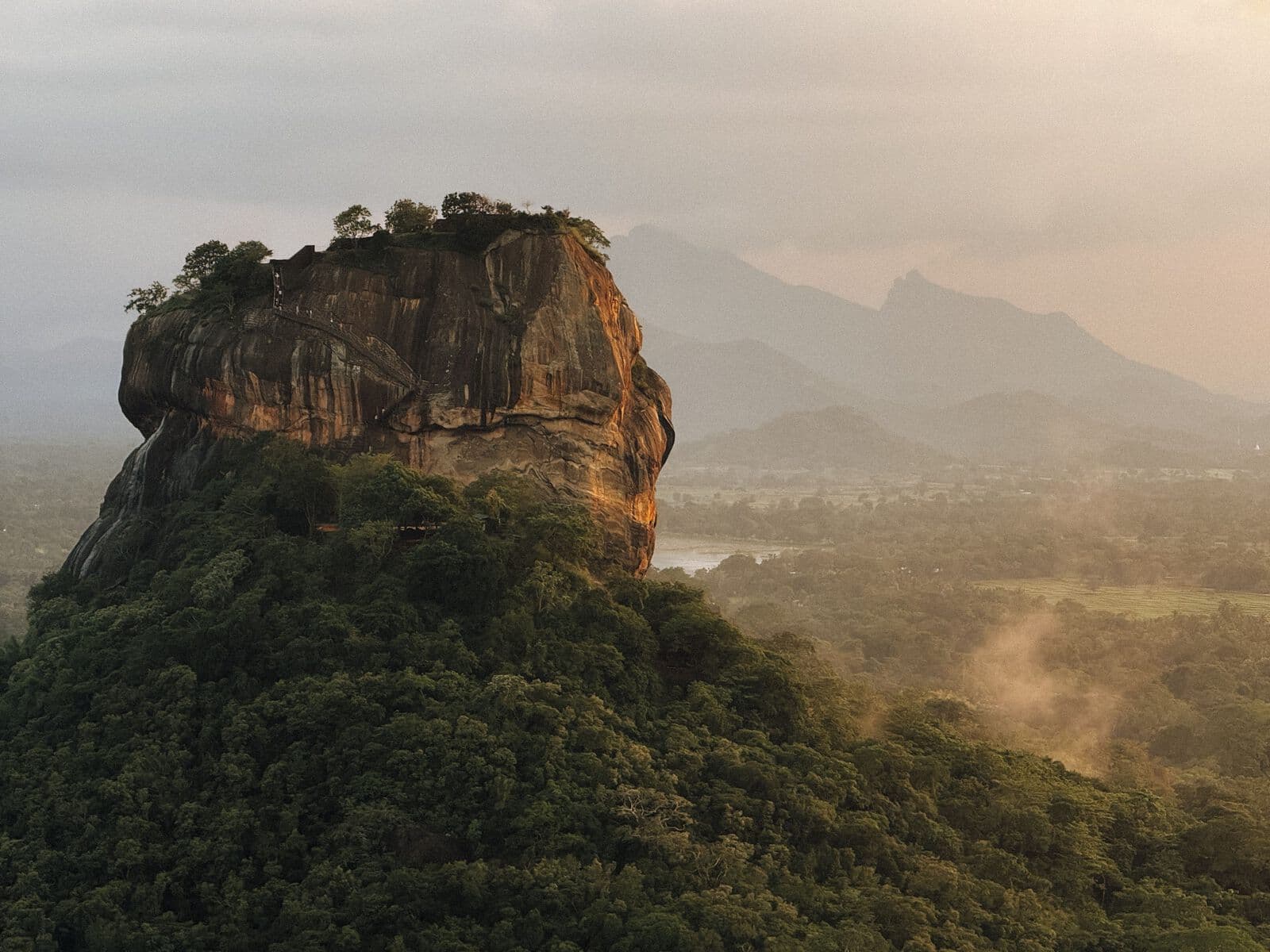 Sigiriya rock fortress above the jungle at sunset