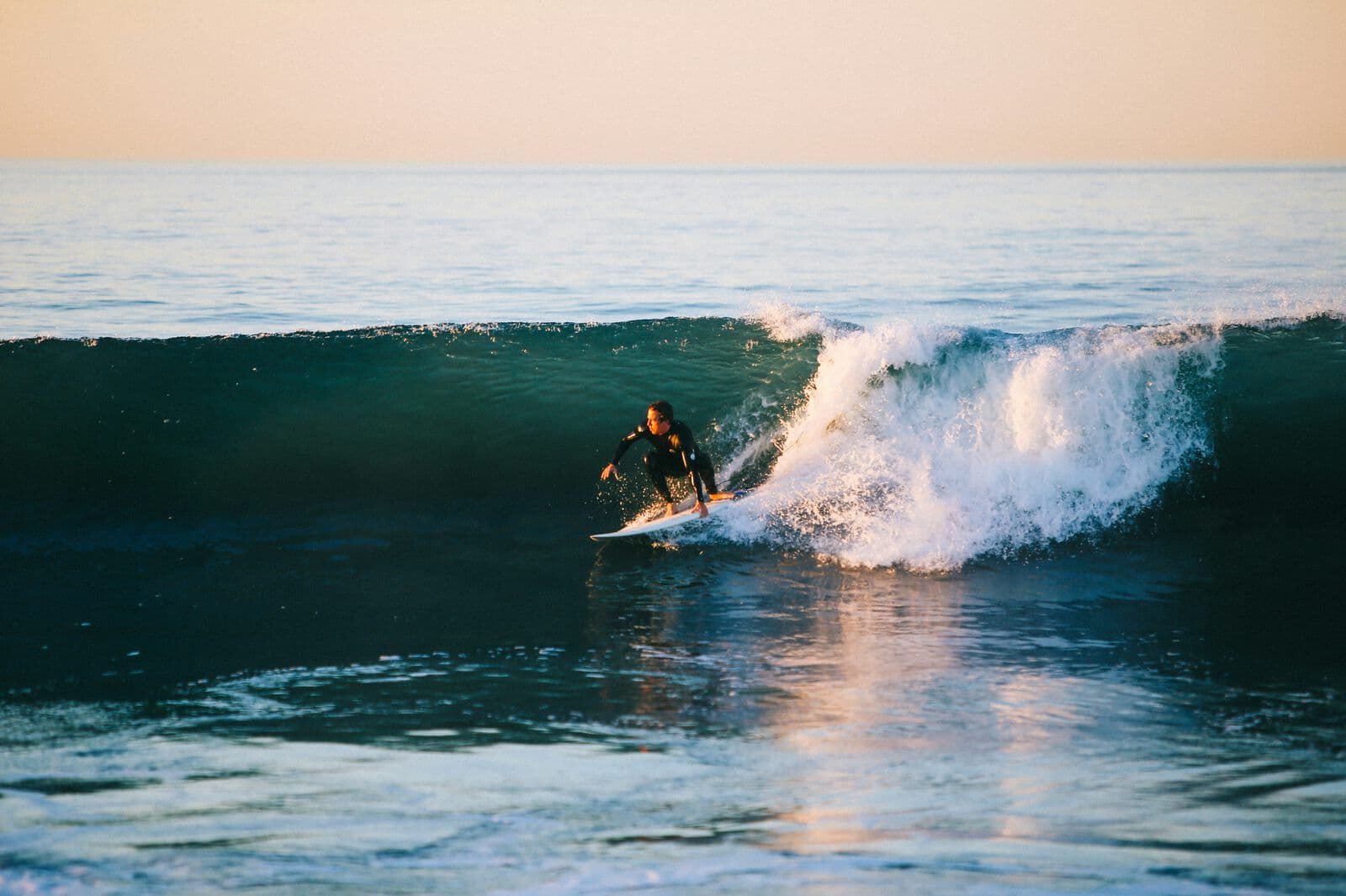 A surfer inside the barrel of a wave